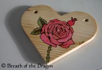 pyrography with watercolor - pink rose on heart-shaped wood