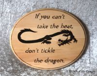 oval plaque with long thin dragon and quote