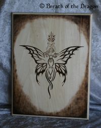 large plaque featuring unique butterfly/angel/goddess design