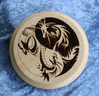 circular plaque featuring a pair of dragons in a yin yang pattern