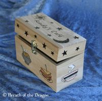recipe card box featuring kitchen imagery on the sides and a sun, moon, and stars on the lid