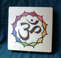 square box with rainbow lotus leaves encircling a large om symbol in the center of the lid