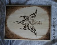 large plaque featuring unique butterfly/angel/goddess design