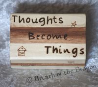 small multi-color wood box featuring “Thoughts Become Things” and various symbols, pyrography by Sunfire