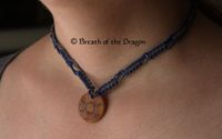 small round wooden charm featuring Triple Moon design hanging from blue and grey hemp macramé necklace, pyrography and macramé by Sunfire